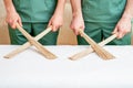 Massage bamboo brooms in hands