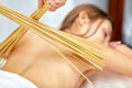 Massage with bamboo sticks Royalty Free Stock Photo