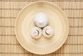 Massage bundles on a plate on a bamboo mat