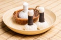 Massage bundles on a plate on a bamboo mat