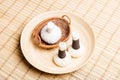 Massage bundles on a plate on a bamboo mat