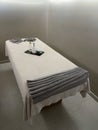 a massage cabin prepared to attend a client, with a massage table with towels, essential oils and creams for massage Royalty Free Stock Photo