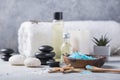 SPA concept: composition of spa treatment with natural sea salt, aromatic oil and flowers on wooden background, close up, top view Royalty Free Stock Photo