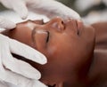 Massage, facial and relax with black woman in spa for holistic treatment, beauty and skincare. Peace, luxury and zen