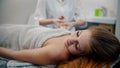 Massage - female young massage therapist massaging hands of her woman client Royalty Free Stock Photo