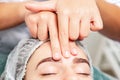 Massage of forehead of woman