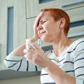 Massage his temples. A woman suffering from a headache. Health problems,. Woman holding her head with her hand Royalty Free Stock Photo