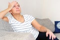 Massage his temples. A woman suffering from a headache. Health problems,. Woman holding her head with her hand Royalty Free Stock Photo