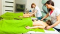 Massage with hot rocks stones in beautician Royalty Free Stock Photo