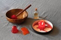 Massage items: oil, singing bowl, vacuum can and scented candle on textile linen background Royalty Free Stock Photo