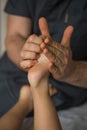 Massage. masseuse doing foot reflexology to child at spa. Royalty Free Stock Photo