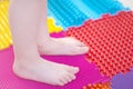 Massage mat for children. girl walking on massage mat.