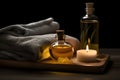 Massage oil bottles, towel and candle on the table on black background. Skin care and relax concept. Generative AI Royalty Free Stock Photo