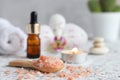 Massage set with pink himalayan salt, essential oil, scented candle, orchid flower, zen stones and towel. Beauty and spa Royalty Free Stock Photo