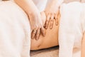 Massage on the side of a pregnant woman - contraindications to massage Royalty Free Stock Photo