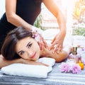 Relaxing body massage for beautiful asian young woman. Royalty Free Stock Photo