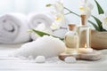 Massage Stones, Essential Oils, and Sea Salt for Spa Procedures on White Wooden Table Royalty Free Stock Photo