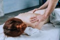 Massage therapist doing massotherapy of a young woman, elbow joint massage. Beautiful relaxed  young woman Royalty Free Stock Photo