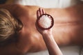Massage therapist hold bowl with salt in hand Royalty Free Stock Photo