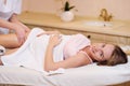 Massage therapist makes a foot massage for a pregnant woman Royalty Free Stock Photo