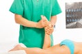 Massage therapist stretching kid's legs and foots Royalty Free Stock Photo