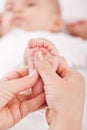 Massaging baby feet Royalty Free Stock Photo