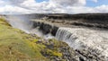 Masses of water cascade down the mighty Dettifoss, creating a misty spray at the edge.