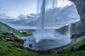 Masses of water from the Seljalandsfoss waterfall cascade down into a lake. Royalty Free Stock Photo