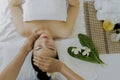Masseur doing massage the head of an Asian woman in the spa salon Royalty Free Stock Photo