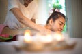 Masseur doing massage spa with treatment on Asian woman body in the Thai spa lifestyle, so relax and luxury. Royalty Free Stock Photo