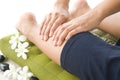 Masseur giving lady patient a leg massage . Royalty Free Stock Photo