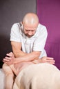 Masseur hands doing spine and back massage, neck and hand. Relaxed patient enjoys. Man hands massaging female. Spa Royalty Free Stock Photo