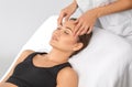 Masseur makes a relaxing massage on the face, neck, shoulders and collarbones of a young beautiful woman in a spa. Cosmetology and