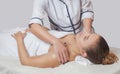 Masseur makes a relaxing massage on the face, neck, shoulders and collarbones of a young beautiful woman in a spa. Cosmetology and Royalty Free Stock Photo