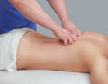 Masseur makes a relaxing massage on the neck, shoulders and back of a young beautiful woman in a spa. Cosmetology and massage