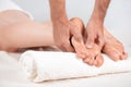 The masseur massages the pads of the feet of the girl who is lying on the massage table. Very close-up, soft light pastel light