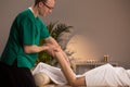 Masseur massaging lower limb