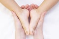 Masseur massaging a small childrens foot. Mother is doing massage on her baby foot. Royalty Free Stock Photo