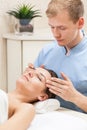 Masseur massaging woman in spa