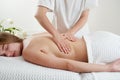 Masseur massaging young woman on massage table in spa salon. Young woman relaxing during back massage at the spa. Spa Royalty Free Stock Photo