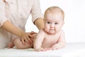 Masseur or mother massaging baby girl Royalty Free Stock Photo