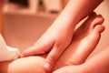 Masseur providing a foot massage to a client.