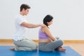 Masseur rubbing pregnant womans shoulders Royalty Free Stock Photo