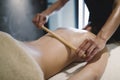 Masseur using massage bamboo sticks Royalty Free Stock Photo