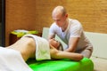 Masseur works on woman arms doing traditional Thai massage on female body in the spa salon. Beauty treatment concept