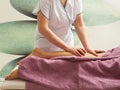 Masseuse doing legs massage with hot stones Royalty Free Stock Photo