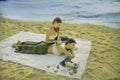 Masseuse doing massage and spa for young beautiful asian women who are sleeping on white cloth on sand beach, with concept of Royalty Free Stock Photo