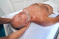 Masseuse hands massaging man neck at wellness center Royalty Free Stock Photo