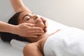 Masseuse hands massaging relaxed black lady face Royalty Free Stock Photo