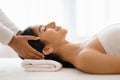 Masseuse making relaxing head massage for young beautiful indian lady Royalty Free Stock Photo